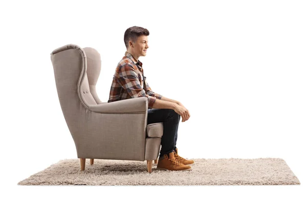 Profiel Foto Van Een Jonge Man Zit Een Fauteuil Geïsoleerd — Stockfoto