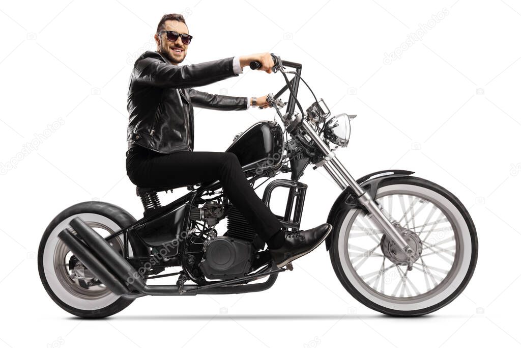 Handsome man biker on a custom chopper isolated on white background