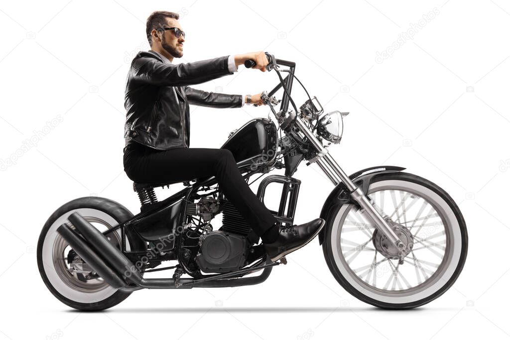 Profile shot of a biker on a custom chopper riding with sunglasses isolated on white background