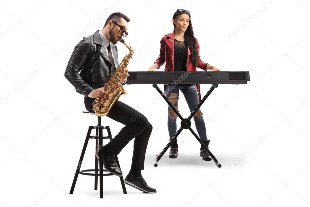 Young man and woman musicians performing on a sax and a keyboard isolated on white background