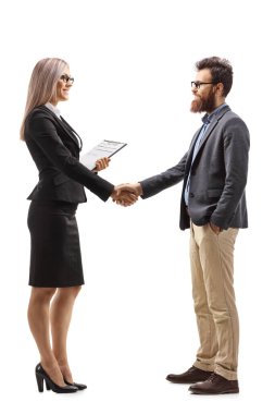 Full length profile shot of a businesswoman shaking hands with a bearded man isolated on white background clipart