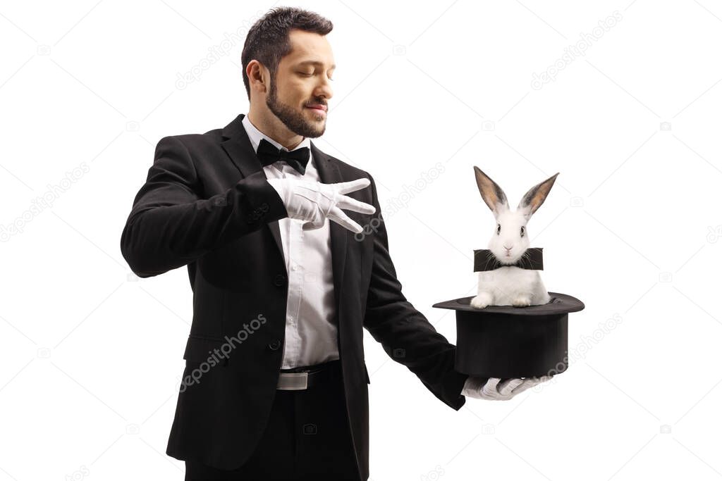 Magician performing a trick with a top hat and a rabbit isolated on white background