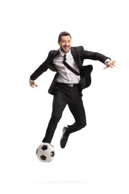 Full length portrait of a happy businessman playing football isolated on white background clipart