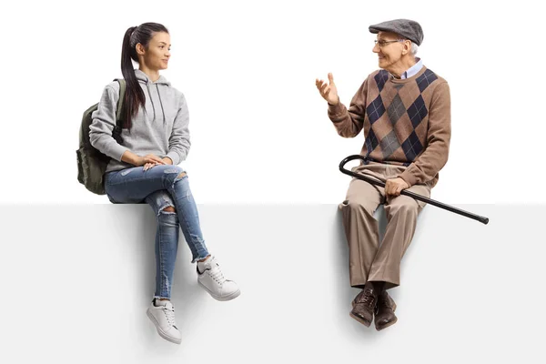 Female student sitting on a panel and listening to an elderly man talking isolated on white background