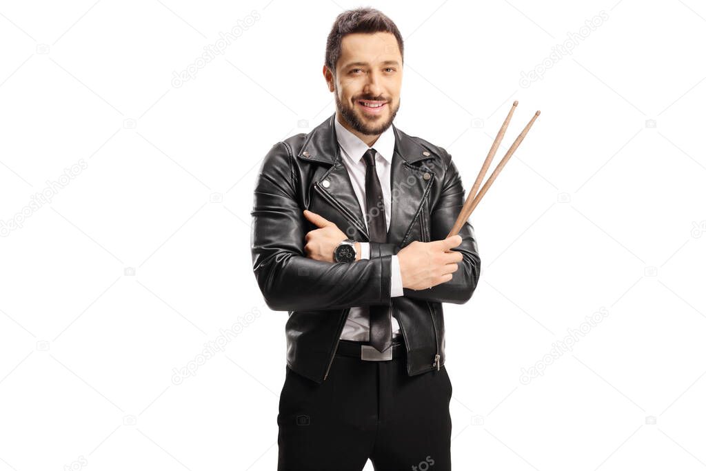 Man in a leather jacket holding a pair of drumsticks isolated on white background