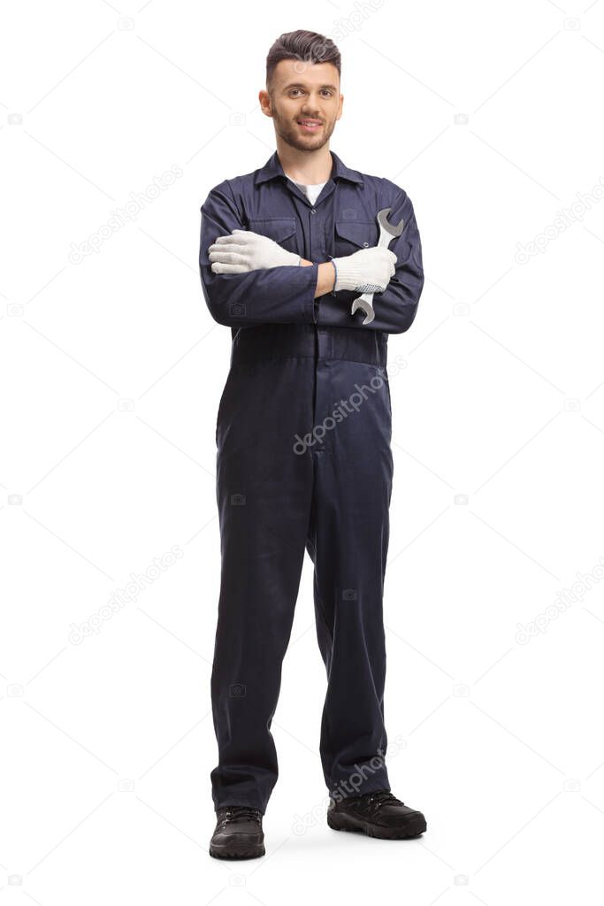 Auto mechanic holding a wrench and posing isolated on white background