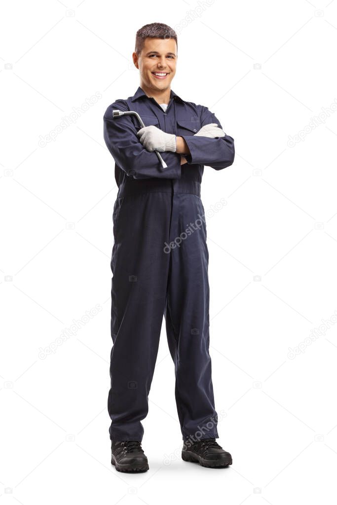 Full length portrait of a mechanic holding a wrench and posing isolated on white background