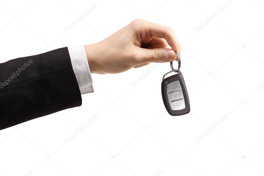 Male hand in a suit and white shirt holding car keys isolated on white background