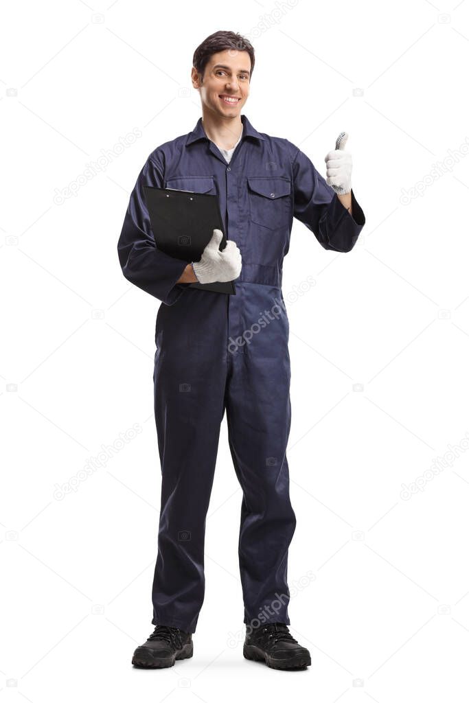 Full length portrait of a male worker in a uniform holding a clipboard and showing thumbs up isolated on white background