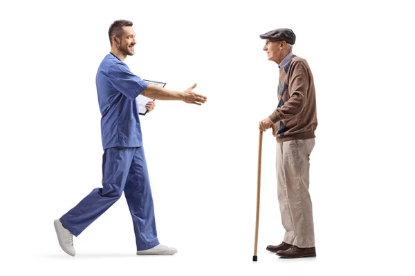 Medical Worker Greeting Hand Elderly Man Walking Cane Isolated White — Stock Photo, Image