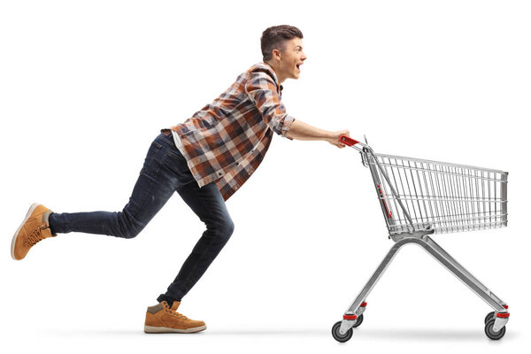 Young man running with an empty shopping cart isolated on white background