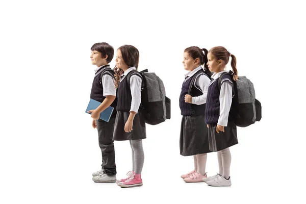 Beyaz Arka Planda Izole Edilmiş Üniformalı Dört Okul Çocuğundan Oluşan — Stok fotoğraf