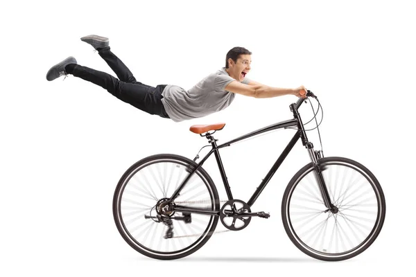 Chico Volando Sosteniendo Una Bicicleta Aislada Sobre Fondo Blanco — Foto de Stock