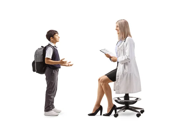 Full Length Profile Shot Schoolboy Talking Young Female Doctor Seated — Stock Photo, Image