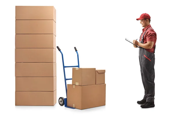 Full Length Profile Shot Male Worker Looking Stack Boxes Writing — Stock Photo, Image