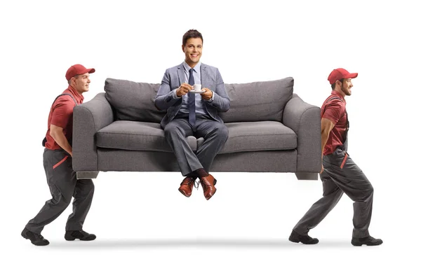 Man Elegant Clothes Sitting Sofa Cup Coffee While Two Movers — Stock Photo, Image