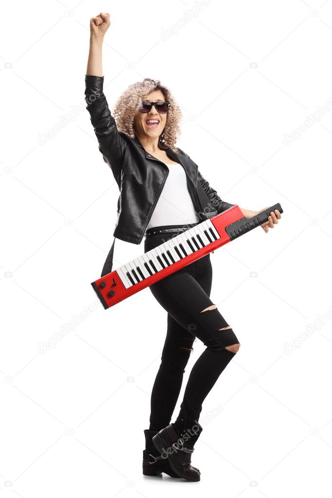 Full length portrait of a female musician with a keytar wearing sunglasses and gesturing with hand isolated on white background