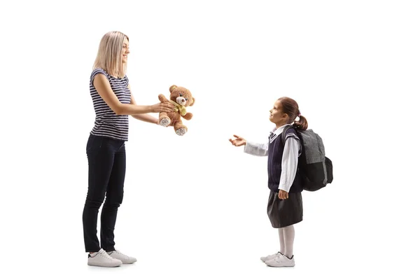 Full Length Profile Shot Woman Giving Teddy Bear Schoolgirl Izolowane — Zdjęcie stockowe