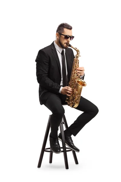 Male Musician Black Suit Playing Saxophone Sitting Chair Isolated White — Stock Photo, Image