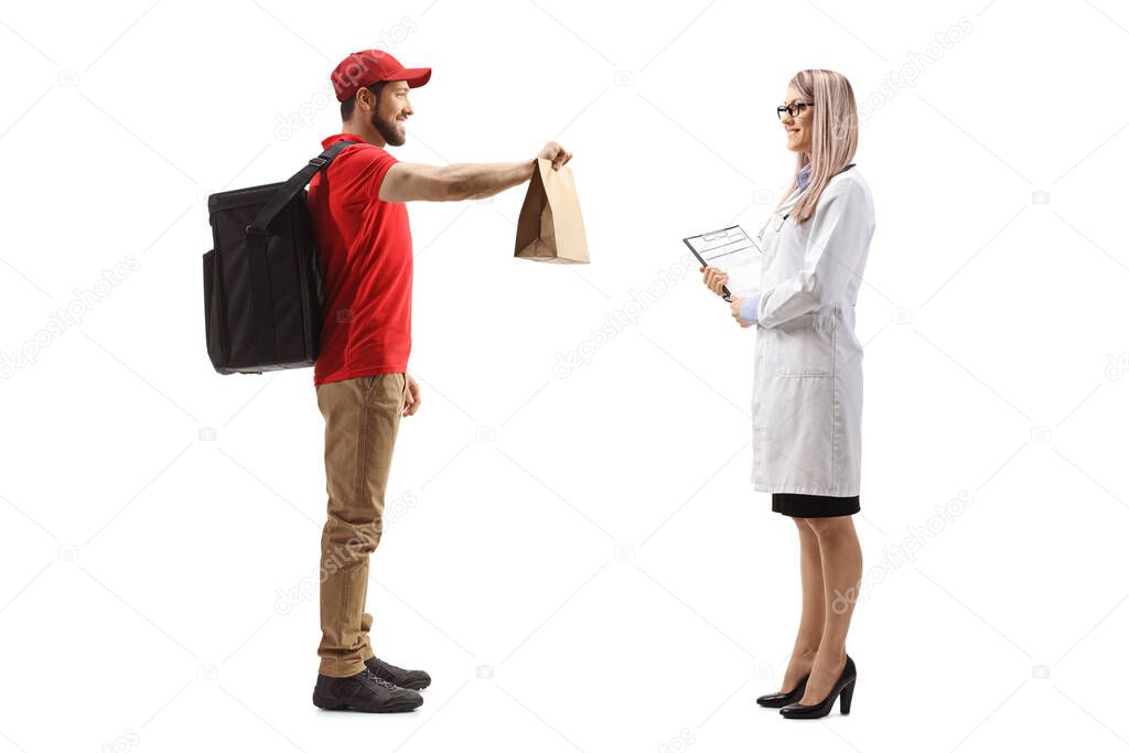Full length profile shot of a guy delivering food to a female doctor isolated on white background