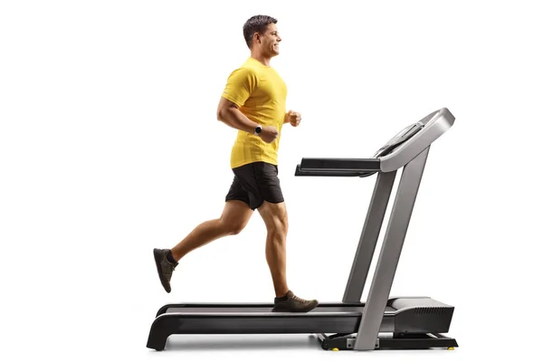 Full Length Profile Shot Strong Young Man Running Treadmill Isolated — Zdjęcie stockowe