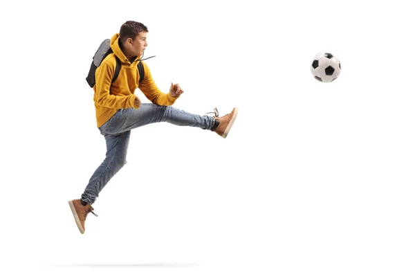 Полнометражный Снимок Подростка Прыгающего Пинающего Футбольный Мяч Белом Фоне — стоковое фото