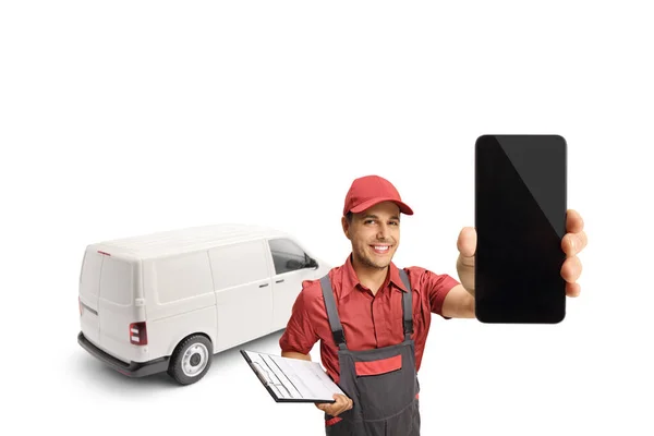 Delivery guy with a van holding a clipboard and a smartphone isolated on white background