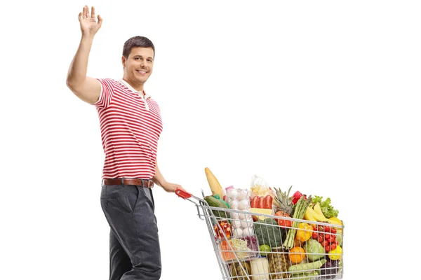 Mann Mit Einkaufswagen Lächelt Und Winkt Isoliert Auf Weißem Hintergrund — Stockfoto
