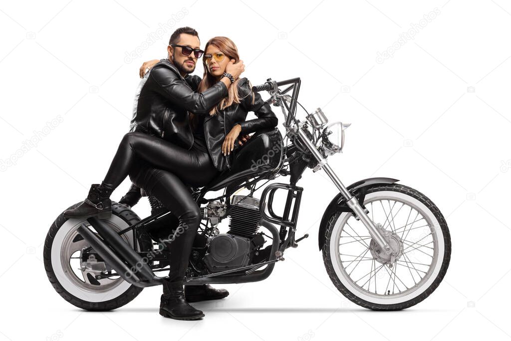 Bikers couple sitting on a chopper motorbike in embrace isolated on white background