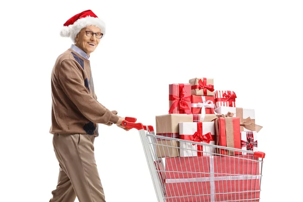 Elderly Man Santa Claus Hat Pushing Shopping Cart Presents Looking — Stock Photo, Image