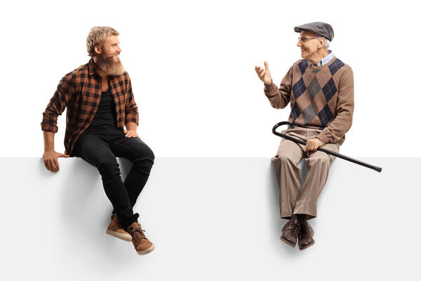 Elderly man talking to a bearded guy and sitting on a white panel isolated on white background