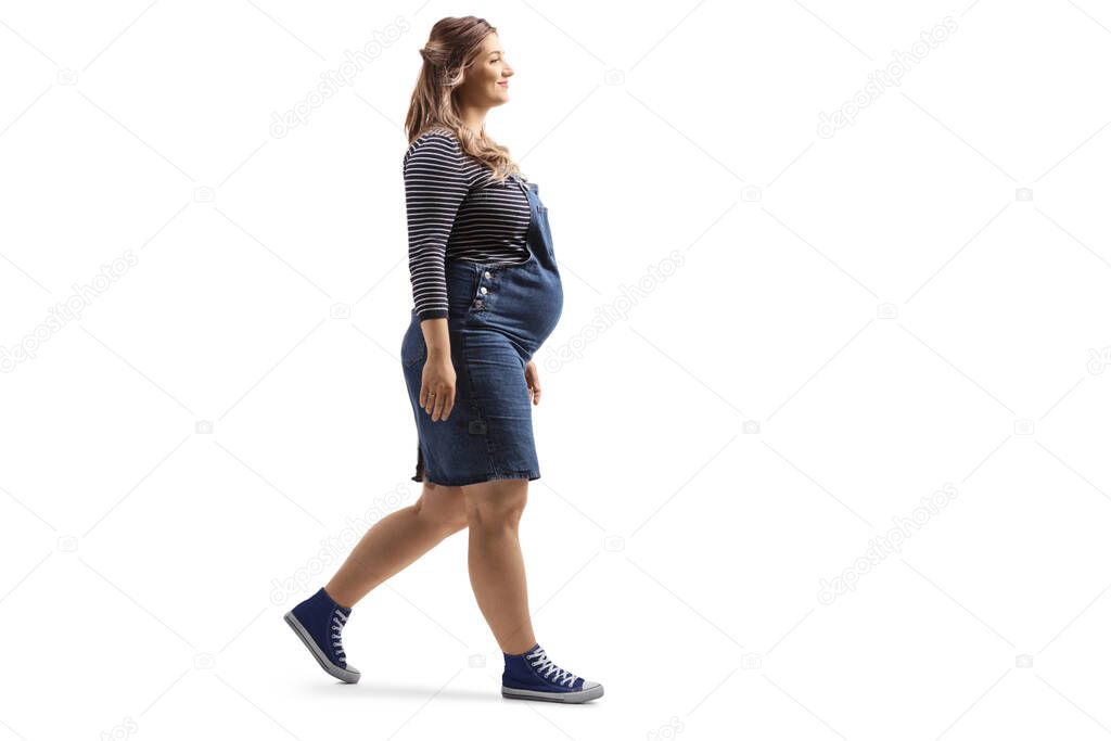 Full length shot of a pregnant woman walking isolated on white background