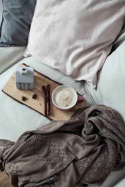 Home decor. Mug cappuccino, plaid, wooden tray, sofa Cozy Autumn Fall