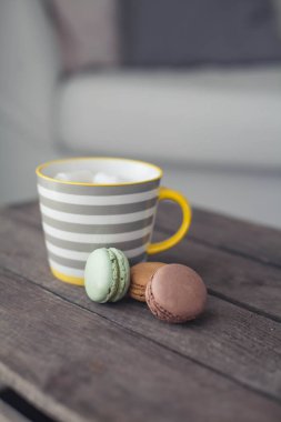 Ahşap bir masa üzerinde marshmallow ile sıcak kakao bir fincan. Bademli kurabiye. Tatlı. Kahvaltı. Rahat. Sonbahar.