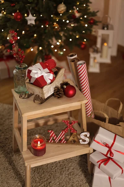 Christmas mood. Gifts, wrapping paper, candles, Christmas tree. Scenery. Holidays. Christmas. New Year.
