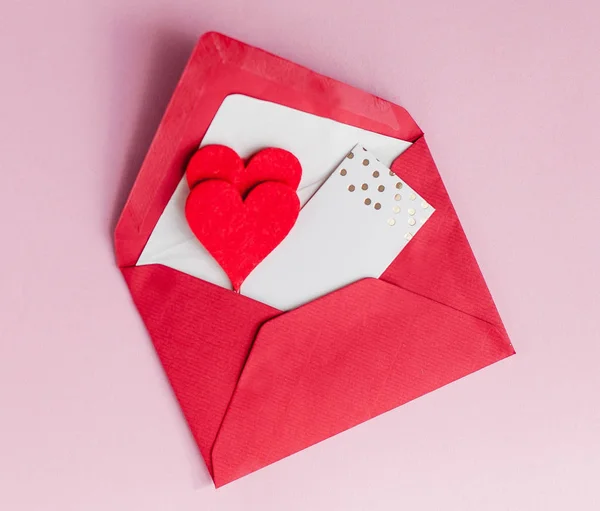 Valentine\'s day concept. Valentine, hearts, card on a pink background. Holidays.