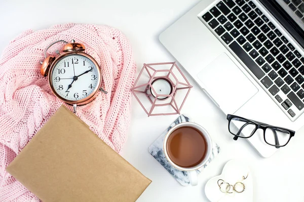 Spring decor. Womens clothing. Alarm clock, gift box with a pink ribbon, jewelry, a candle, a mug of tea, glasses, a notebook on a white background.