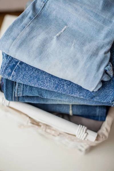 Jeans in een witte rieten mand. — Stockfoto