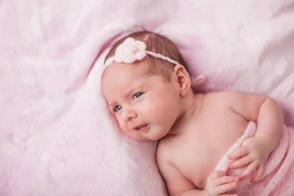 Little newborn baby in a pink suit on a pink background. Motherhood. — Stock Photo, Image