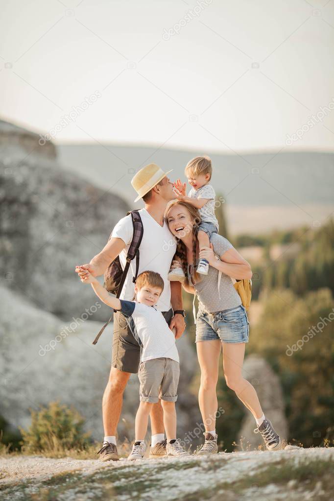 Beautiful family in the mountains. Tourism. Campaign. Fall.
