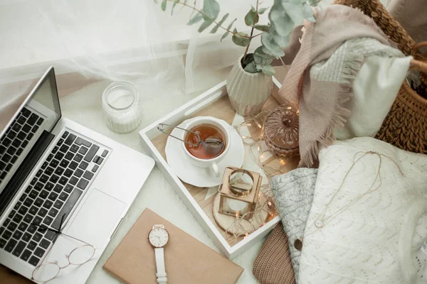 Foto tonica. Arredo autunnale. Un portatile, una tazza di te 'caldo, un panino, delle candele. Accogliente. Autunno . — Foto Stock