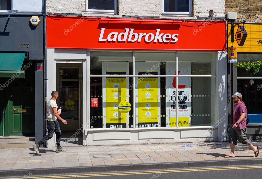 Bromley (Greater London), Kent, UK. Ladbrokes betting shop in Widmore Road, Bromley with pedestrians walking past. Ladbrokes bookmakers in Bromley.