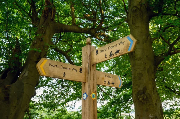 A sign on the North Downs Way near Woldingham in Surrey, England, UK. The North Downs is part of the Surrey Hills Area of Outstanding Natural Beauty. The North Downs Way is a national trail.
