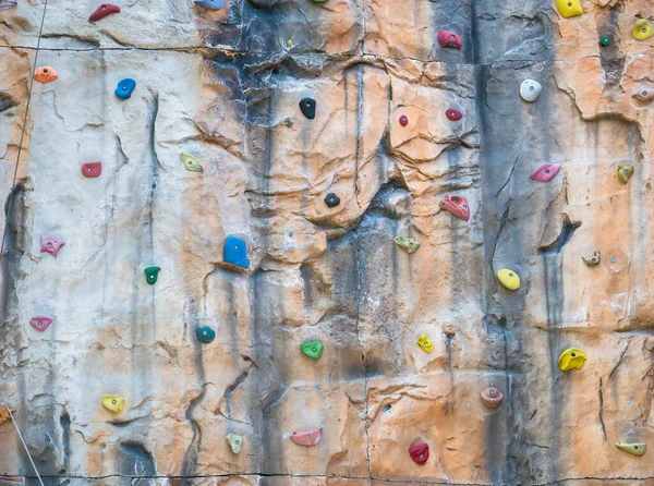 Detail with an artificial climbing wall. Wall with climbing holds