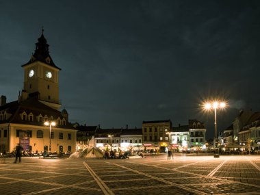 Brasov / Romanya - 06.28.2020: Brasov belediye binası eski belediye meclisi meydanında yer alıyor. Brasov 'un ana meydanı gün batımında ya da gece.