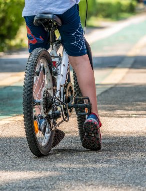 Bükreş / Romanya - 08.07.2020: Bükreş 'teki Herestrau parkında bisiklet süren çocuklar