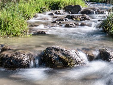 Romanya 'nın Karpat Dağları' ndaki kayalar arasında akan bir dağ deresi veya dere resmi. Piatra Mare 'de yedi merdiven kanyonu (Büyük Kaya).