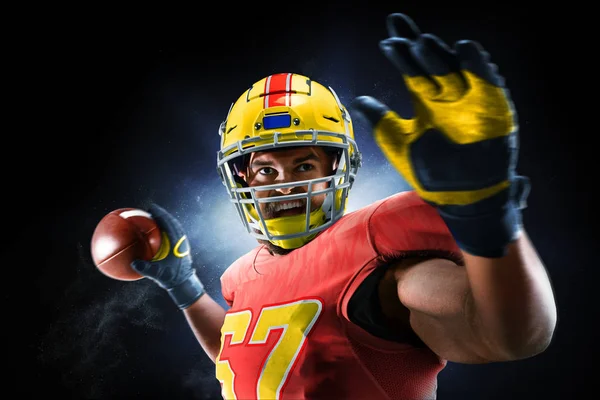 Proud american football player in the dark — Stock Photo, Image