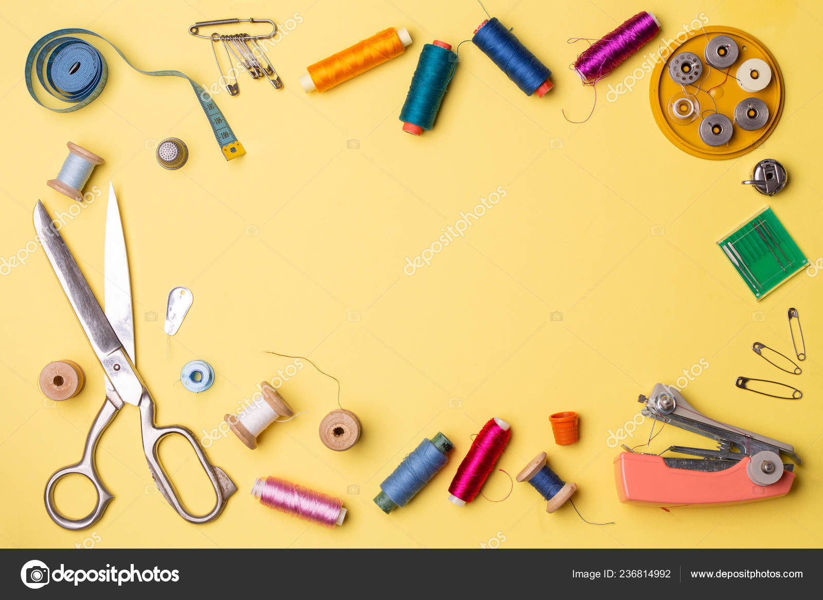 Composition with threads and sewing accessories - scissors, centimeter,  pins on yellow background. Stock Photo by ©nuclear_lily 236814992