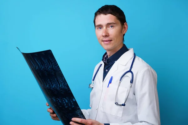 Portrait of a doctor with a stethoscope on the neck and an X-ray in hand — Stock Photo, Image